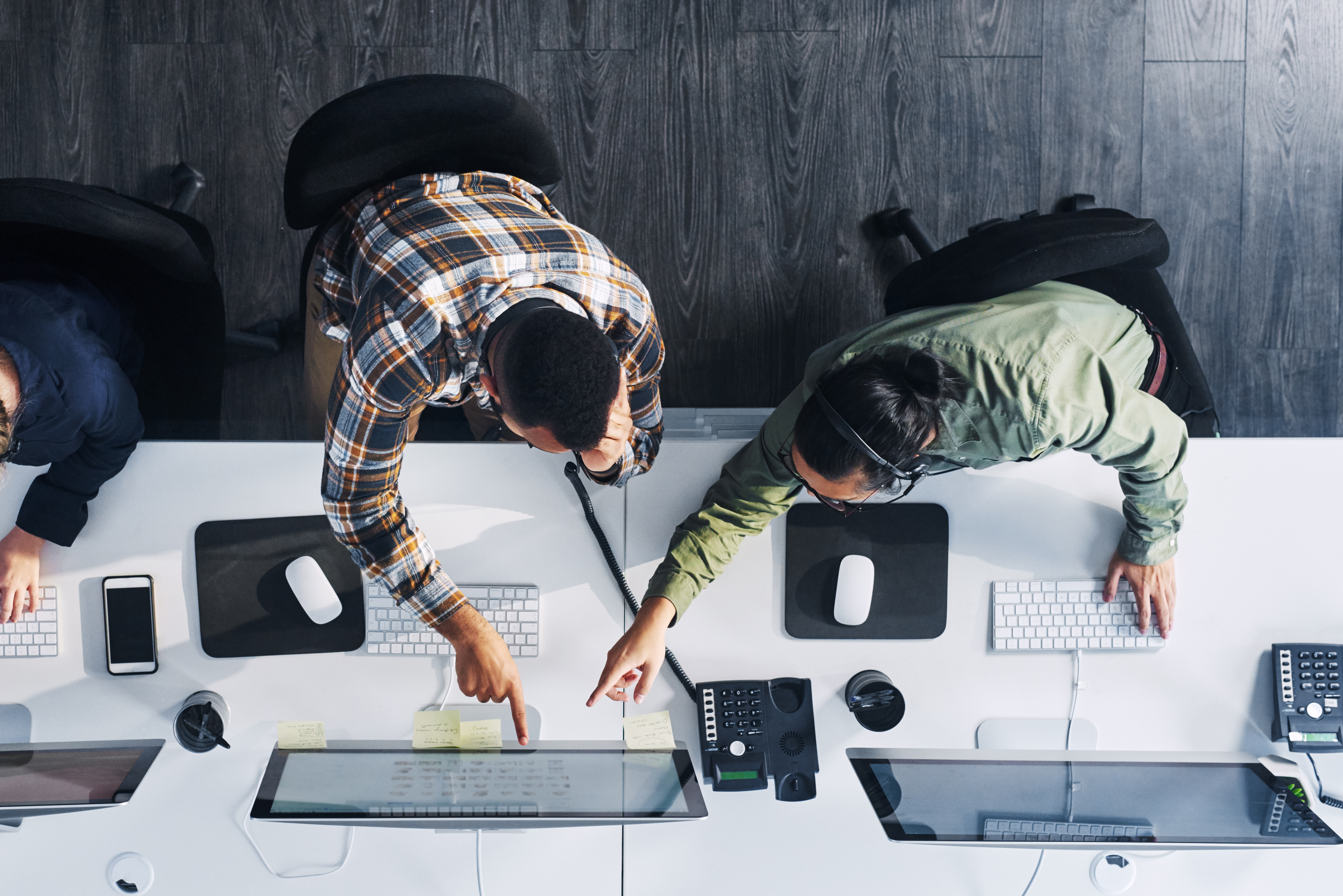 Team reviewing work at a desk
